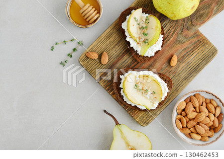 Bruschetta with cream cheese, honey, pear, thyme 130462453
