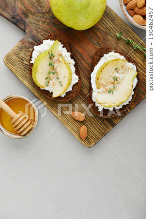 Bruschetta with cream cheese, honey, pear, thyme Bruschetta with cream cheese, honey, pear, thyme 130462457