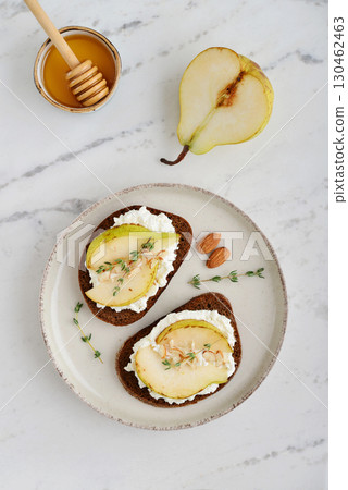 Bruschetta with cream cheese, honey, pear, thyme 130462463