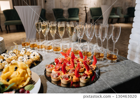Elegant catering with sparkling wine and appetizers at a formal indoor event Elegant catering with sparkling wine and appetizers at a formal indoor event 130463020