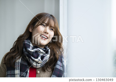 Portrait of a young woman wearing a scarf Portrait of a young woman wearing a scarf 130463049