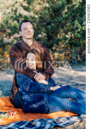 Portrait happy beautiful couple in love enjoying autumn picnic in autumn park. Vertical photo. High quality photo Portrait happy beautiful couple in love enjoying autumn picnic in autumn park. Vertical photo. High quality photo 130463062