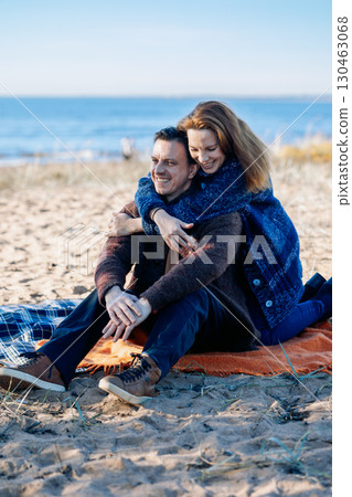 Portrait happy beautiful couple in love enjoying autumn picnic in autumn park. Vertical photo. High quality photo Portrait happy beautiful couple in love enjoying autumn picnic in autumn park. Vertical photo. High quality photo 130463068