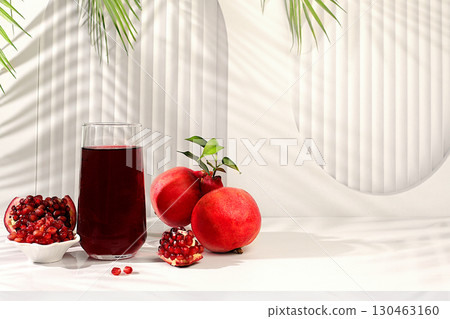 Pomegranate juice drink and ingredients, rich pomegranate drink on elegant sunny table, detox diet and weight loss concept, natural food for healthy lifestyle, source of vitamin C Pomegranate juice drink and ingredients, rich pomegranate drink on elegant sunny table, detox diet and weight loss concept, natural food for healthy lifestyle, source of vitamin C 130463160