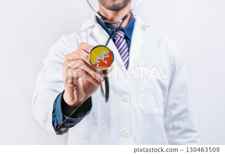 Bhutan healthcare system, doctor holding stethoscope. Bhutan health and medical insurance concept Bhutan healthcare system, doctor holding stethoscope. Bhutan health and medical insurance concept 130463509