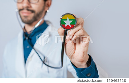 Doctor holding stethoscope with Myanmar flag. Myanmar health and care concept, Myanmar flag on stethoscope Doctor holding stethoscope with Myanmar flag. Myanmar health and care concept, Myanmar flag on stethoscope 130463518