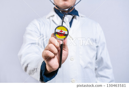 Doctor hands holding stethoscope with Brunei flag. Brunei health and care concept 130463581