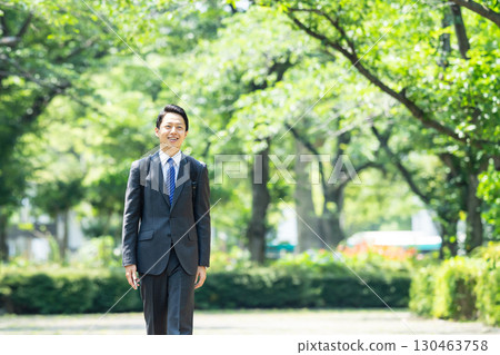 Businessman walking in the park 130463758