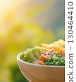 Healthy vegetable salad bowl in sunlight with fresh ingredients 130464410