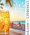 Refreshing iced drink glows in sunset at beachside cafe 130464415