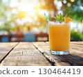 Refreshing orange drink with mint on wooden table outdoors 130464419