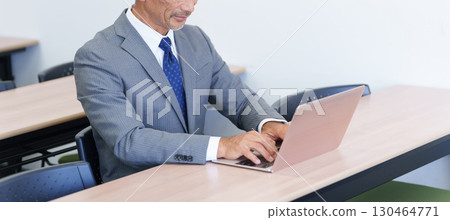Senior businessman using a computer 130464771