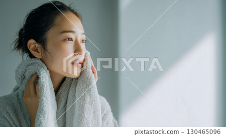 Close-up of a young woman looking clean after washing her face 130465096