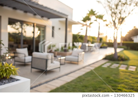Modern Outdoor Living Space with Comfortable Furnishings and Beautiful Sunset Ambiance Modern Outdoor Living Space with Comfortable Furnishings and Beautiful Sunset Ambiance 130466325