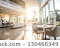 Bright and Modern Cafe Interior with Warm Natural Light and Comfortable Seating Area Bright and Modern Cafe Interior with Warm Natural Light and Comfortable Seating Area 130466349