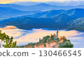 Morning image of a church towering over a sea of clouds 130466545
