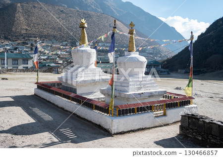 Tibetan Buddhist stupa in Khumjung village, Nepal. Khumjung is one of the most beautiful villages located in the remote area of the Everest region. Tibetan Buddhist stupa in Khumjung village, Nepal. Khumjung is one of the most beautiful villages located in the remote area of the Everest region. 130466857