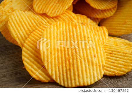 Potato chips in open bag, delicious BBQ seasoning spicy for crips, thin slice deep fried snack fast food. 130467252
