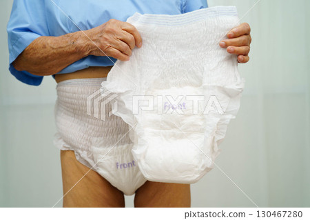 Asian senior woman patient wearing adult incontinence diaper pad in hospital. Asian senior woman patient wearing adult incontinence diaper pad in hospital. 130467280