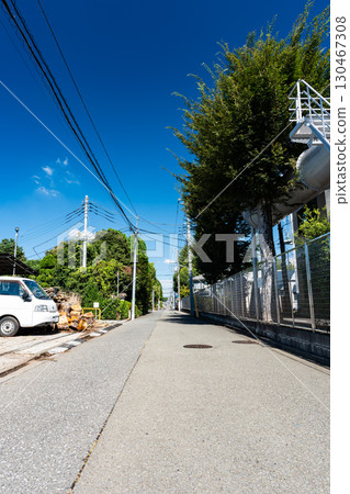 Looking down a straight road under a clear blue summer sky, Jindaiji Higashimachi 6-chome and 7-chome, Chofu City, Tokyo 130467308
