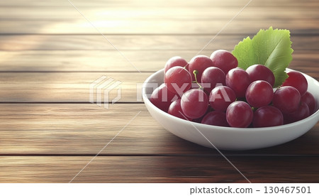 Grapes purple fruit in white ceramic bowl in copy space wooden table 130467501