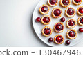 Mini cranberry pie tarts snack dessert homemade in white plate copy space background 130467946