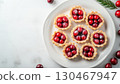 Mini cranberry pie tarts snack dessert homemade in white plate copy space background 130467947