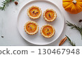 Mini pumpkin pie tarts snack dessert homemade in white plate copy space background 130467948