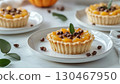 Mini pumpkin pie tarts snack dessert homemade in white plate copy space background 130467950