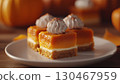 Pumpkin cheese bar slice with vanilla sweet cream topping layered white cream 130467959
