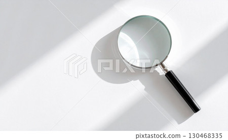 A simple magnifying glass and its shadow on a white background 130468335