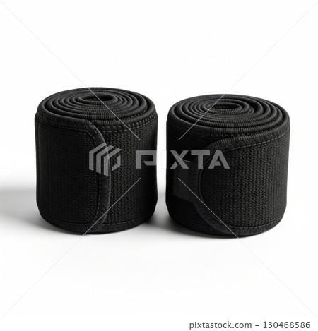 Pair of black elastic compression wraps rolled up 130468586