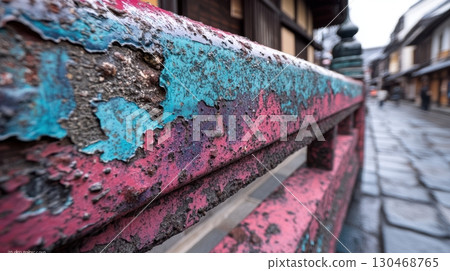 Colorful weathered railing along a quiet street in a traditional Japanese town during a rainy day 130468765