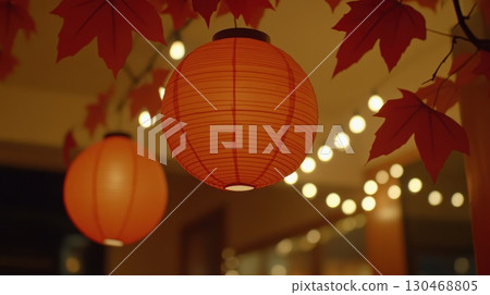 Explore lantern lighting and autumn leaves in cozy indoor setting during evening hours 130468805