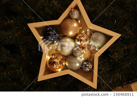 Star-Shaped Ornament Box Filled with Festive Decorations Star-Shaped Ornament Box Filled with Festive Decorations 130468911
