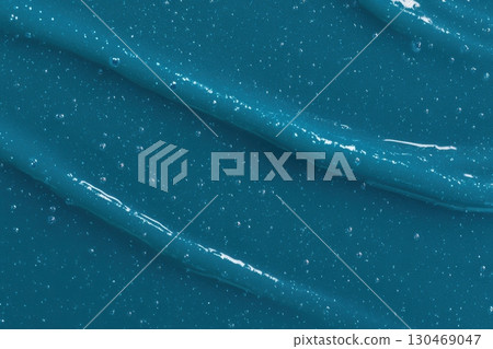 Rich blue gel texture flowing smoothly on a surface with bubbles 130469047