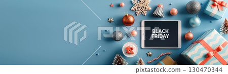 Black Friday sale concept with tablet, ornaments, and gifts. Black Friday sale concept with tablet, ornaments, and gifts. 130470344