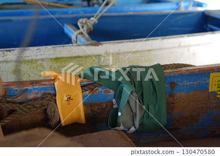 Taking a break by leaving work clothes and tools at the fishing port Taking a break by leaving work clothes and tools at the fishing port 130470580