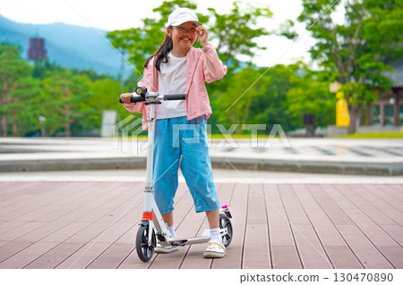 Asian girl is going to ride a scooter. Copy space Asian girl is going to ride a scooter. Copy space 130470890