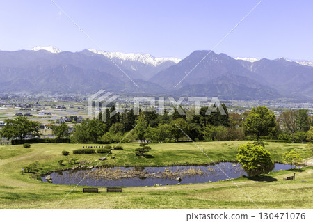 A spectacular view of the Northern Alps from Azumino Ikeda Craft Park, with its pond and lawn A spectacular view of the Northern Alps from Azumino Ikeda Craft Park, with its pond and lawn 130471076