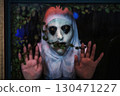 Scary devilish nun look through window at night.Haloween 2025 130471227