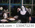 Scary devil nun sip tea on cup at dinner table. 2025 Halloween party 130471230