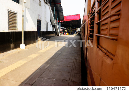 Indian Railway Train Stopped at a Platform with Passengers in Distance Indian Railway Train Stopped at a Platform with Passengers in Distance 130471372