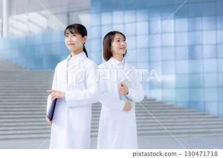 Portrait of a woman wearing a white coat 130471718