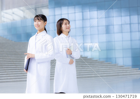 Portrait of a woman wearing a white coat 130471719
