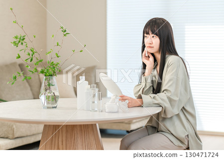 A woman who takes care of her skin to keep it moisturized (worries, worries, problems, skin troubles, complexes) 130471724