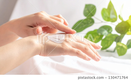 Skin care scene of applying cream to hands 130471764