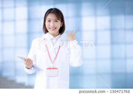 Portrait of a woman wearing a white coat 130471768
