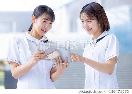 Medical nurse woman looking at tablet 130471975