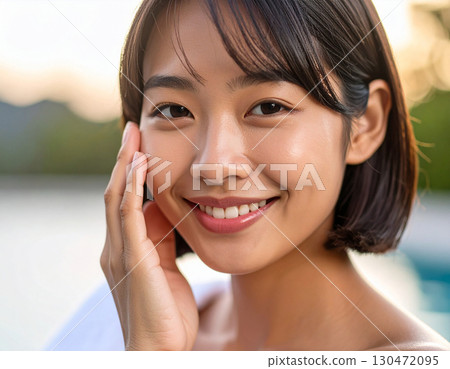 Young woman with hand on cheek 130472095